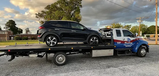 DD Towing flatbed tow truck hauling a black SUV in Timmonsville, SC